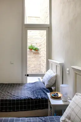 a small bedroom with a bed and a window at MeMeraki Artist Residency in Limassol
