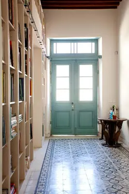a green door in a hallway with a table at MeMeraki Artist Residency in Limassol