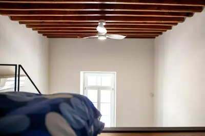 a room with a ceiling fan and a window at MeMeraki Artist Residency in Limassol