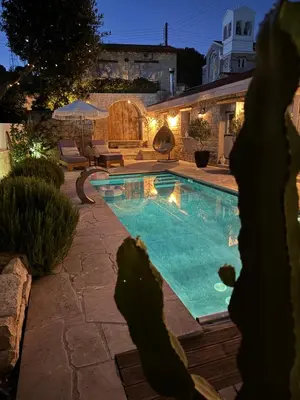 a swimming pool in a backyard at night at Fig&Olive Luxury one bedroom boutique in Pachna in Limassol