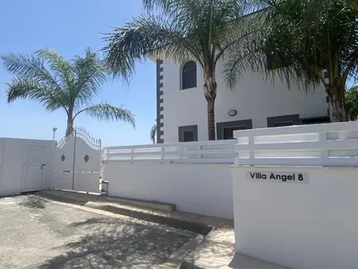 a white fence in front of a house with palm trees at Villa Angel - Exotic Villa 200m From Beach in Paralimni