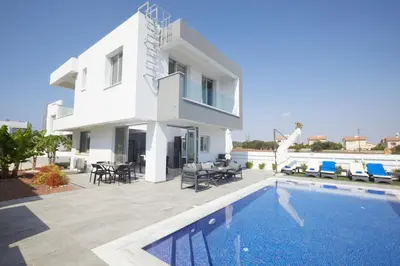 a villa with a swimming pool and a house at Protaras Pearl Villa Ekaterina in Protaras