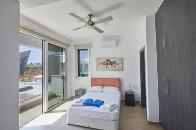a bedroom with a bed and a ceiling fan at Protaras Pearl Villa Ekaterina in Protaras