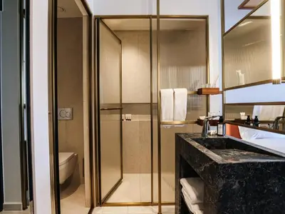 a bathroom with a shower and a sink and a toilet at The Nines in Ayia Napa
