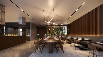 a restaurant with tables and chairs and a chandelier at The Nines in Ayia Napa