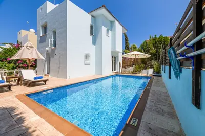 a swimming pool in a villa with a house at Villa Lela Serena by Ezoria Villas in Protaras