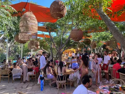 a crowd of people sitting at tables at a party at Villa Lela Serena by Ezoria Villas in Protaras