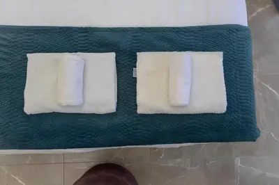 two towels are sitting on top of a green floor at White Arches Apt #2 by TrulyCyprus in Limassol