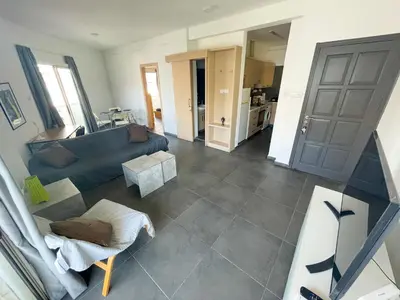 a living room with a couch and a table at High Speed Holiday Apartment in Larnaka