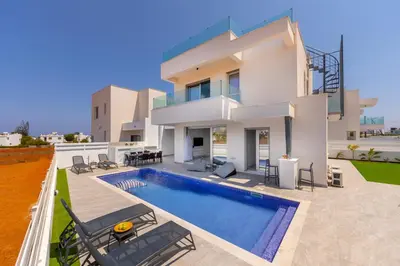 a villa with a swimming pool and a house at Protaras Sol e Mar Villa 3 in Protaras
