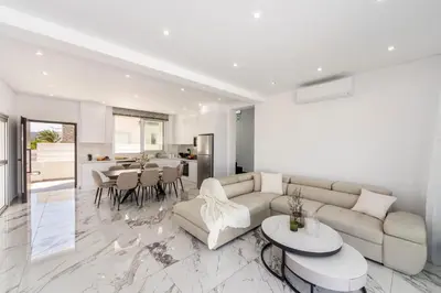 a living room with a couch and a table at Protaras Sol e Mar Villa 3 in Protaras