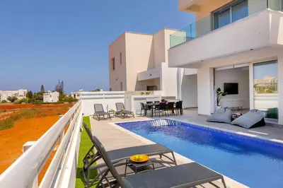 a villa with a swimming pool and a house at Protaras Sol e Mar Villa 3 in Protaras