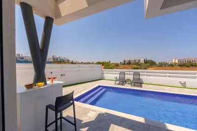a patio with a swimming pool on the roof of a building at Protaras Sol e Mar Villa 3 in Protaras