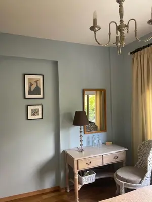 a bedroom with a desk and a mirror and a chair at T&L Apartments Germasogia in Limassol