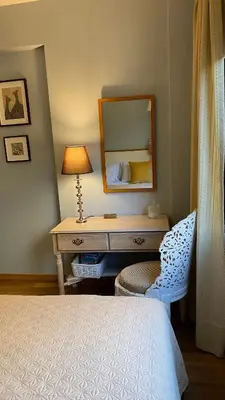 a bedroom with a desk and a mirror and a bed at T&L Apartments Germasogia in Limassol