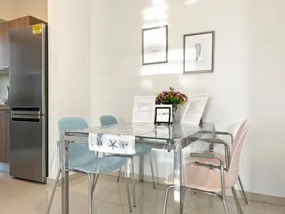 a glass dining room table with chairs and a refrigerator at Albert's apartment St. Lazarus 401 in Larnaka