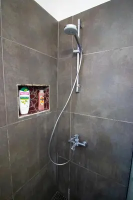 a shower with a hose in a bathroom at 2-bedroom appartment in center in Nicosia