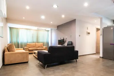 a living room with two chairs and a couch at 2-bedroom appartment in center in Nicosia