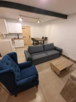 a living room with a couch and a table at Aprosmeno Jacuzzi House 3 With Private Pool in Agros