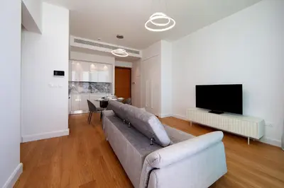 a living room with a couch and a flat screen tv at Sky Tower in Limassol