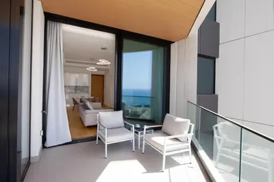 a balcony with two chairs and a table and a couch at Sky Tower in Limassol
