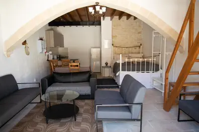 a living room with a couch and a table at Cleo's Inn in Lofou
