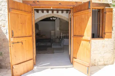 an open door to a patio with a living room at Cleo's Inn in Lofou