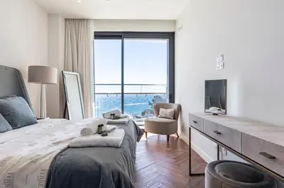 a bedroom with a bed and a desk with a tv at Del Mar Beachfront 'C' 2 Bedroom Residence in Limassol