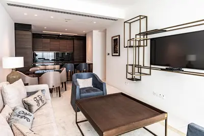 a living room with a couch and a tv at Del Mar Beachfront 'C' 2 Bedroom Residence in Limassol