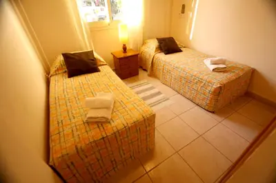 a hotel room with two beds and a mirror at Alonia Villas in Pissouri