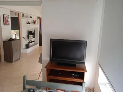 a living room with a flat screen tv on a wooden stand at Nicosia rest and relax 1 bedroom apartment in Nicosia