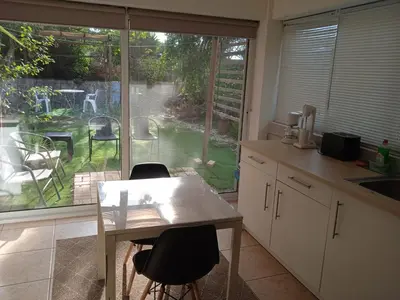 a kitchen with a table and chairs and a window at Nicosia rest and relax 1 bedroom apartment in Nicosia