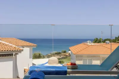 a table with a towel and a basket of fruit on a balcony at Pelagos apartment 6 in Paralimni