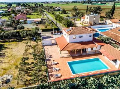 an aerial view of a house with a swimming pool at Reel Paradise Villa, Cyprus in Larnaka