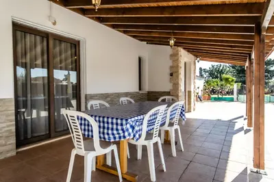 a table and chairs on the patio of a house at Reel Paradise Villa, Cyprus in Larnaka