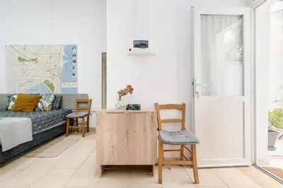 a living room with a bed and a table and chairs at Cozy and Traditional - EC Studios in Larnaka