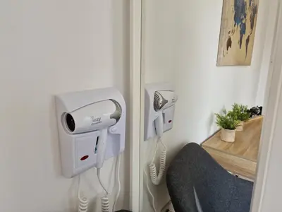 a room with two hair dryers on a wall at Villa Green garden in Ayia Napa