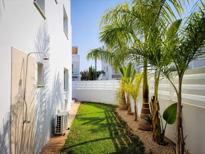 a courtyard with palm trees in a house at Villa Green garden in Ayia Napa