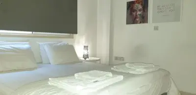 a white bed with towels on top of it at ELLA LUXURY APARTMENT - (BREAKBOOKING CY) in Limassol