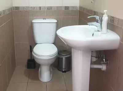 a bathroom with a white toilet and a sink at ELLA LUXURY APARTMENT - (BREAKBOOKING CY) in Limassol