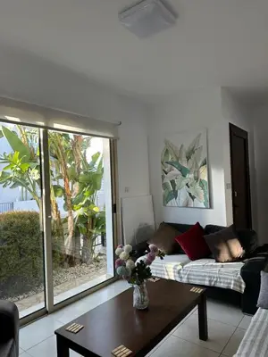 a living room with a couch and a table at LC Palm Villa in Protaras