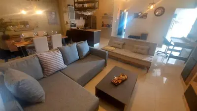 a living room with a couch and a table at Paramount Gardens Resorts C201 in Larnaka