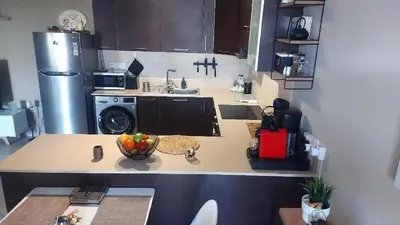 a kitchen with a bowl of fruit on a counter at Paramount Gardens Resorts C202 in Larnaka
