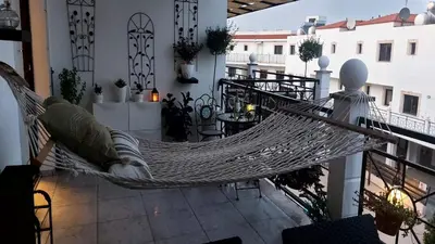 a hammock on the balcony of a building at Paramount Gardens Resorts C202 in Larnaka