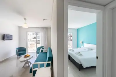 a hotel room with a bed and a table and chairs at Mia Hotel Apartment in Ayia Napa