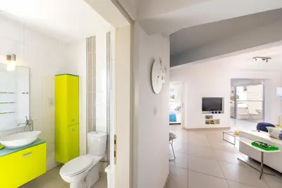 a bathroom with a white toilet and a sink at Protaras Pallini 201 Seaside Suite in Protaras