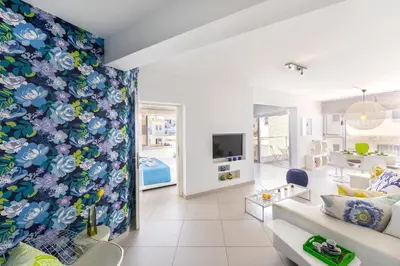 a living room with a blue and white wall at Protaras Pallini 201 Seaside Suite in Protaras