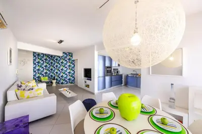 a dining room and living room with a table and chairs at Protaras Pallini 201 Seaside Suite in Protaras