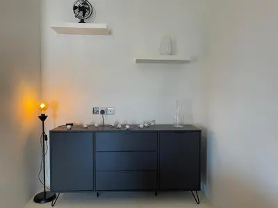 a black dresser with a lamp in a room at Urban Retreat - Your Ideal Getaway in Limassol in Limassol