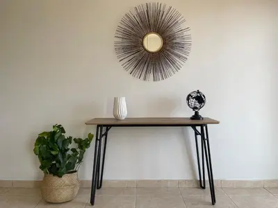 a table with a mirror on the wall with a plant at Urban Retreat - Your Ideal Getaway in Limassol in Limassol
